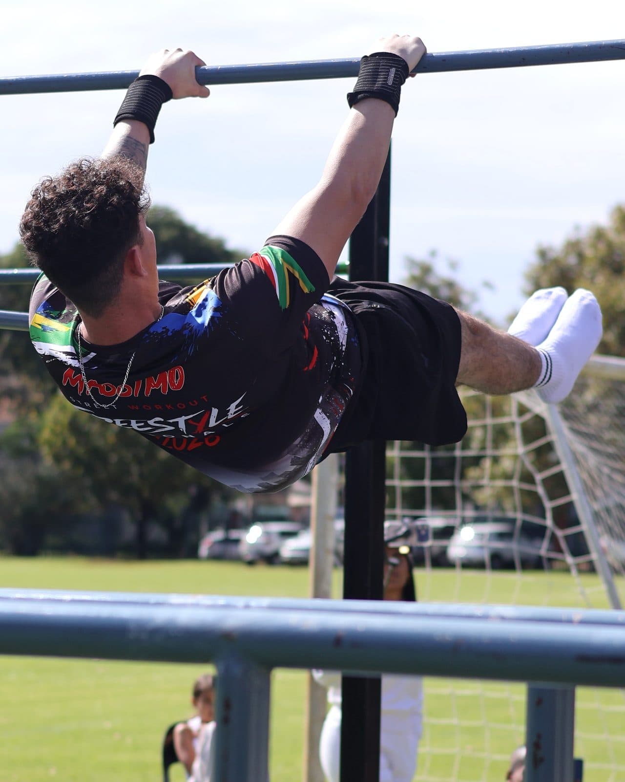 A SASWCA athlete holding a front lever on a horizontal bar at the 2026 Freestyle Nationals.